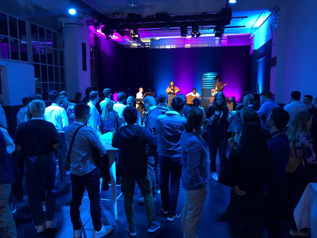 Concert with audience in a dimly lit venue.