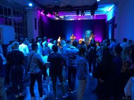 Concert with audience in a dimly lit venue.