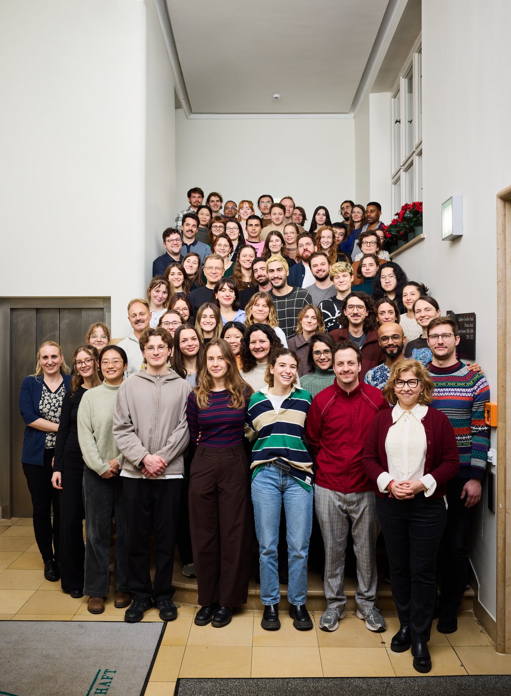 Many people gather on a staircase.